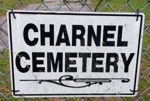 Charnel Cemetery sign located on fence gate