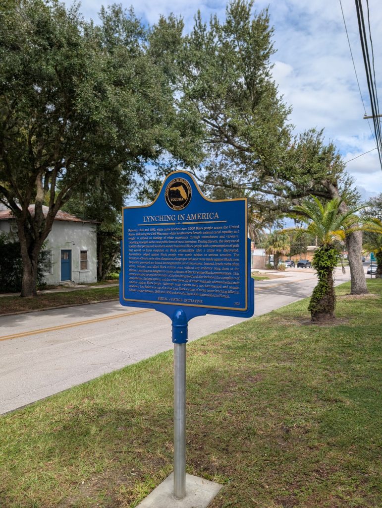 Lynching in America wide view of historic marker on Rich Avenue in DeLand, FL
